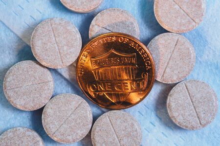 One cent coin with pillsの写真素材