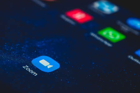 Zoom icon app and other messenger icon app on the screen smartphone closeup. Zoom Video Communications is a company that provides remote conferencing services.のeditorial素材