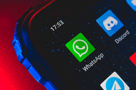 WhatsApp icon on the screen smartphone. WhatsApp is free texting and calling application for mobile phones and computers.のeditorial素材