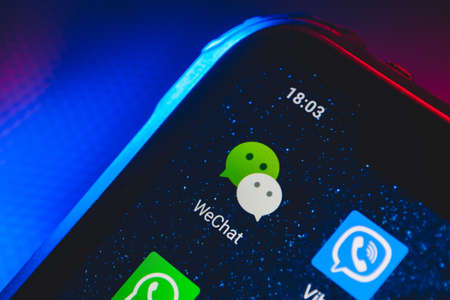 WeChat app icon on the screen smartphone. WeChat is a Chinese multi-purpose messaging, social media and mobile payment app.のeditorial素材