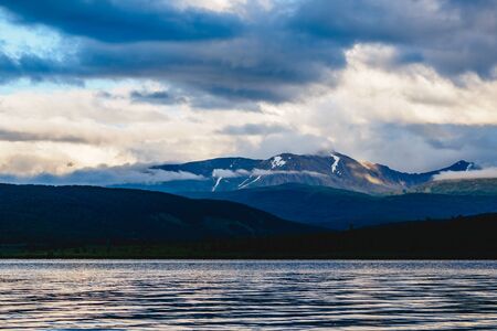 Spectacular view of a mountain range in clouds near a lake in Ulagansky district of the Altai Republic, Russiaの写真素材