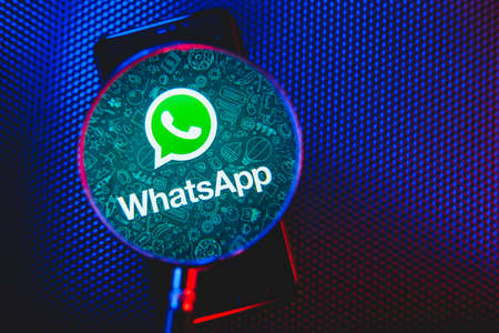 Whatsapp logo on the screen smartphone closeup. WhatsApp is free texting and calling application for mobile phones and computers.のeditorial素材