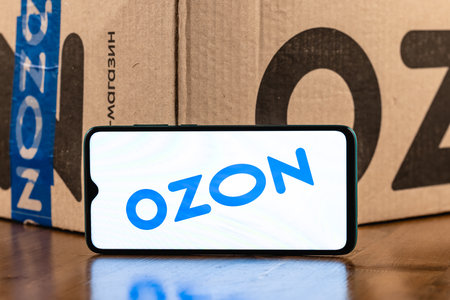 Ozon logo on the screen smartphone closeup. Ozon is one of the first e-commerce companies in Russia. Smartphone on the background of the parcel.のeditorial素材