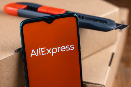 Aliexpress logo on the screen smartphone. AliExpress is an online retail service based in China owned by the Alibaba Group.のeditorial素材
