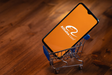 Alibaba logo on the screen smartphone. Alibaba Group Holding Limited is a Chinese multinational technology company specializing in e-commerce, retail, Internet.のeditorial素材