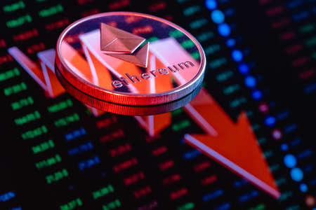 Ethereum coin on the background of a large red arrow pointing down. The concept of the falling rate...