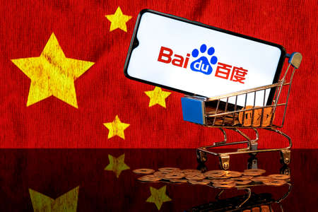 Kazan, Russia - August 16, 2021: Baidu is a Chinese multinational technology company. A smartphone with the Baidu logo in food basket on the background of the Chinese flag.のeditorial素材