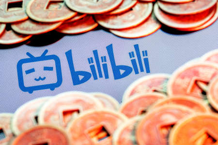 Kazan, Russia - August 23, 2021: Bilibili is a Chinese video sharing website themed around animation, comics, and games. Bilibili logo surrounded by blurred feng shui coins.のeditorial素材