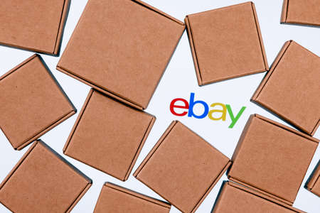 Kazan, Russia - Sep 25, 2021: eBay is an e-commerce corporation that offers online shopping, auction and marketplace services. Ebay logo on a white background surrounded by parcel boxes.のeditorial素材