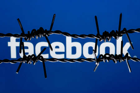 Kazan, Russia - Oct 19, 2021: Facebook social network behind barbed wire. The concept of facebook...
