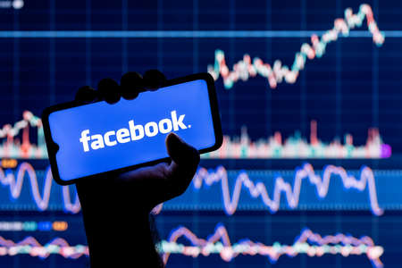 Kazan, Russia - Oct 19, 2021: A smartphone with the facebook social network in hand. Facebook stock...