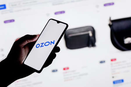 Kazan, Russia - Nov 10, 2021: Ozon is a Russian e-commerce company. A smartphone with the Ozon in a hand.のeditorial素材