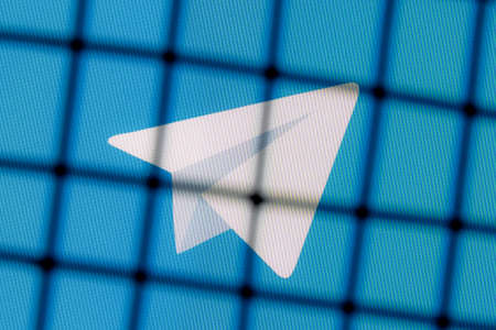 Kazan, Russia - Nov 11, 2021: The of the Telegram messenger behind bars. The concept of Telegram censorship and prohibition.のeditorial素材
