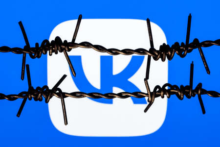Kazan, Russia - Nov 13, 2021: VKontakte social network logo behind barbed wire. The concept of VKontakte censorship and prohibition.のeditorial素材