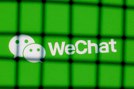 Kazan, Russia - Nov 16, 2021: The logo of the WeChat messenger behind bars. The concept of WeChat censorship and prohibition.のeditorial素材
