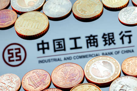 Kazan, Russia - Nov 29, 2021: Variety of metal coins on background of Industrial and Commercial Bank of China logoのeditorial素材