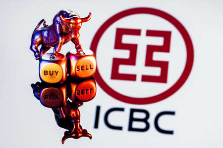 Kazan, Russia - Nov 29, 2021: Metal bull stands on buy-sell dices on background of Industrial and Commercial Bank of China logoのeditorial素材