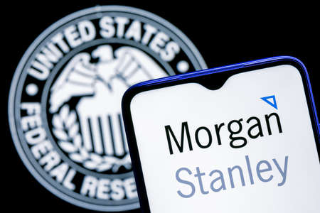 Kazan, Russia - Dec 09, 2021: Smartphone with Morgan Stanley bank logo on background of Federal Reserve symbolのeditorial素材