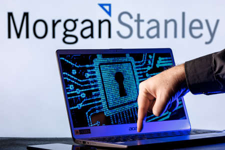 Kazan, Russia - Dec 09, 2021: Laptop with lock symbol on screen on background of Morgan Stanley bank logo. Finger points to lock symbol. Concept of data hacking.のeditorial素材