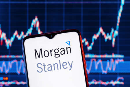 Kazan, Russia - Dec 09, 2021: Smartphone with Morgan Stanley bank logo. Morgan Stanley stock chart on the background.のeditorial素材