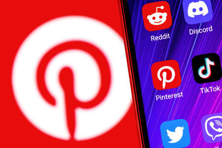 Kazan, Russia - Feb 09, 2022: The icon of the Pinterest social media service application among other applications on the smartphone screen. On the background is the Pinterest .のeditorial素材