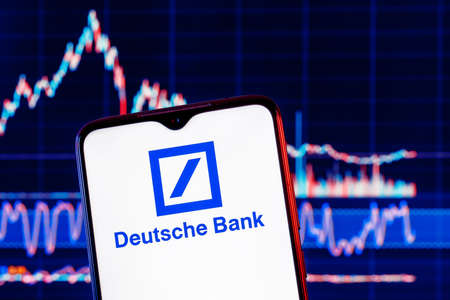 Kazan, Russia - Apr 04, 2022: Smartphone with Deutsche bank logo. Deutsche bank stock chart on the background.のeditorial素材