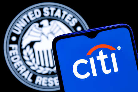 Kazan, Russia - Mar 11, 2022: Smartphone with Citigroup logo on background of Federal Reserve symbolのeditorial素材