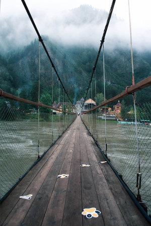 suspension bridge, bridge through the forest. Altai Mountainsの写真素材