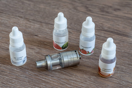 atomizer with liquids close up on a background of wood textureの写真素材