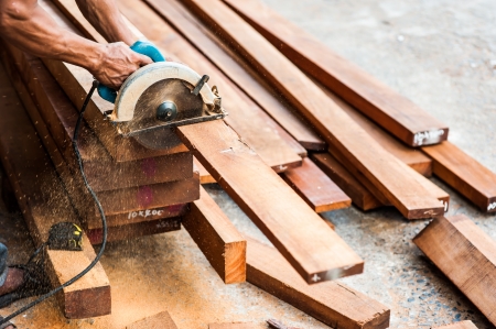 Wood being sawed be electric sawの写真素材