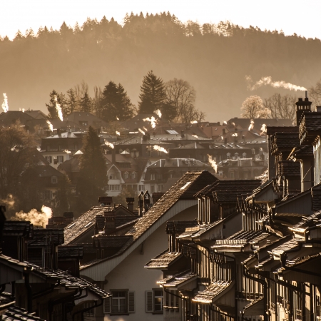 Morning with chimney on roof of housesの写真素材