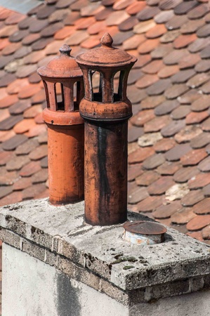 Morning with chimney on roof of housesの写真素材