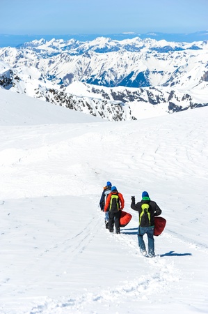 A group of mountain hiker walking on the snow into the mountainの写真素材