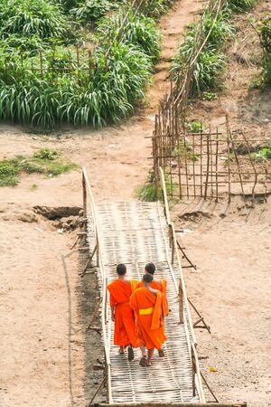 Three monks walking on the way of country sideの写真素材