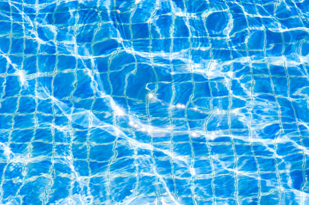 Texture of swimming pool floor trough waterの写真素材