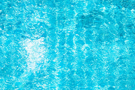 Texture of swimming pool floor trough water waveの写真素材