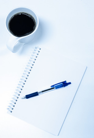Blue Pen on Blank Note with Coffeeの写真素材
