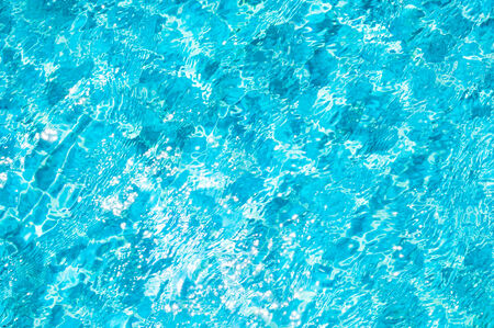 Texture of swimming pool floor trough water waveの写真素材