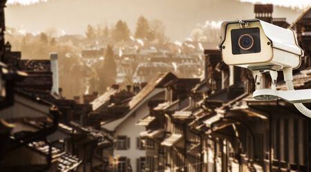 CCTV Camera or surveillance operating on street and buildingの写真素材