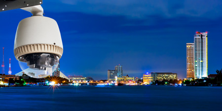 CCTV Camera or surveillance operating with city in backgroundの写真素材