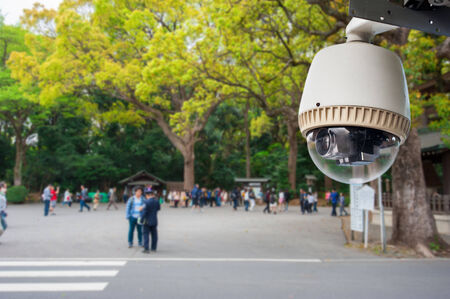 CCTV Camera or surveillance operating in outdoor park with people in japanの写真素材