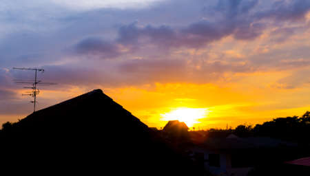 Twilight sky at sunset with silhouette houseの写真素材