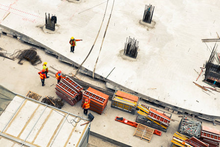 Construction workers working in site lifting toolsの写真素材