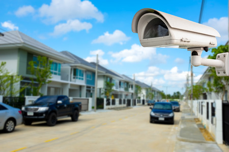 CCTV Camera or surveillance with village in backgroundの写真素材
