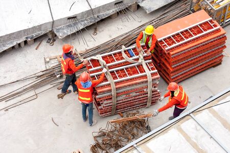 Construction workers working in site lifting toolsのeditorial素材