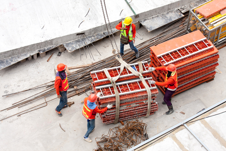 Construction workers working in site lifting toolsのeditorial素材