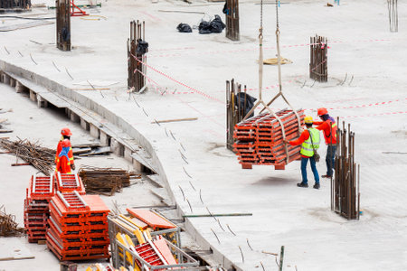 Construction workers working in site lifting toolsのeditorial素材