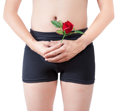 close up of man on black boxer underware  holding red rose isolate on white backgroundの写真素材
