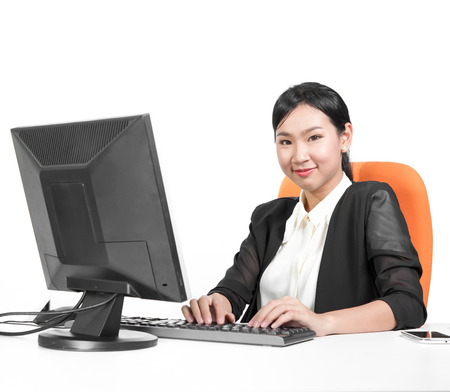 Young pretty business woman using computer on deskの写真素材