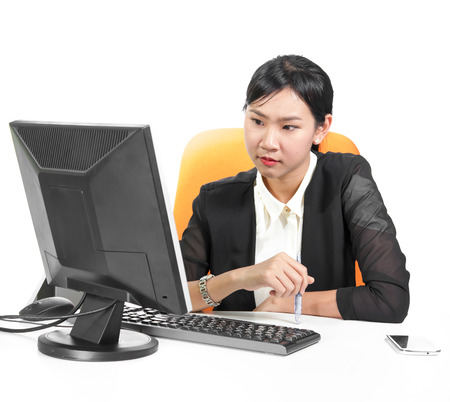 Young pretty business woman using computer on deskの写真素材